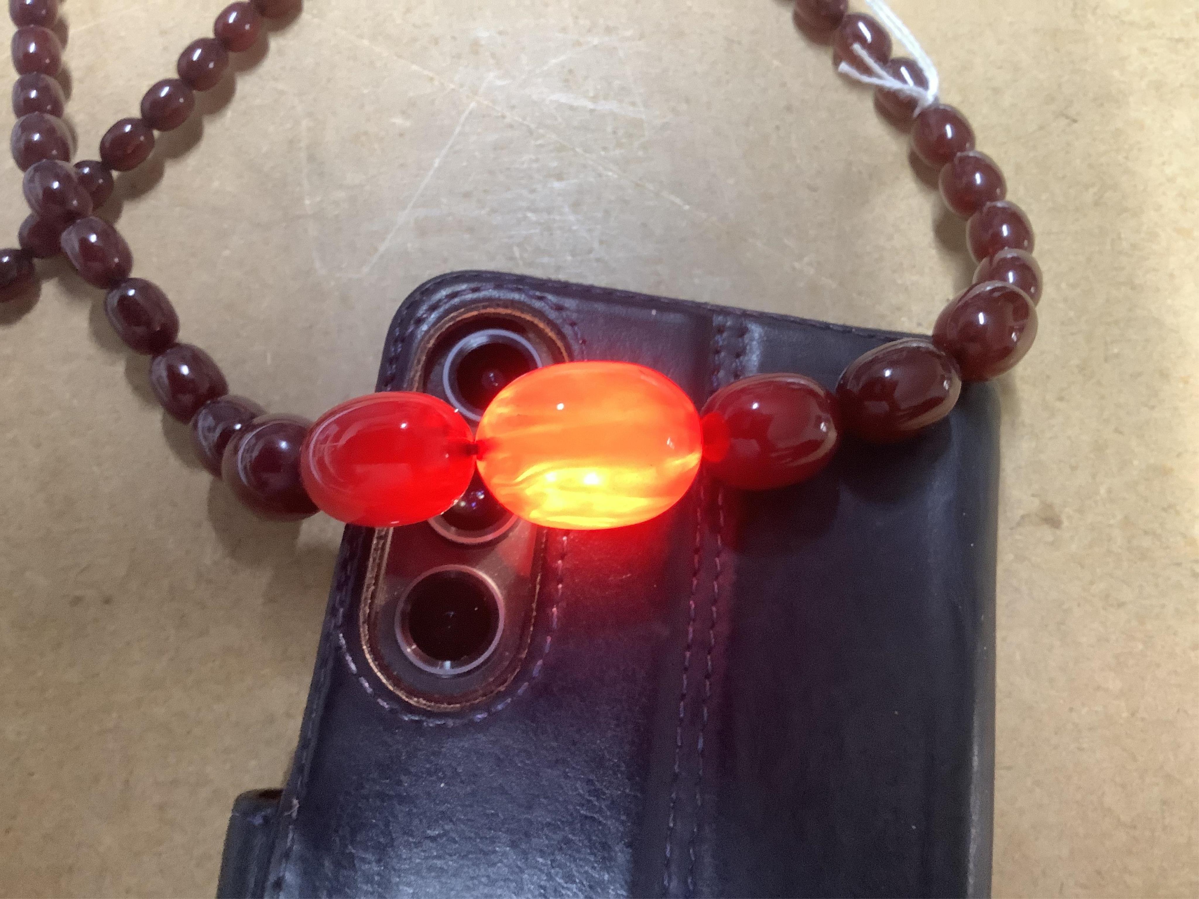 A single strand graduated simulated cherry amber bead necklace, 68cm, gross weight 44 grams. Condition - fair to good